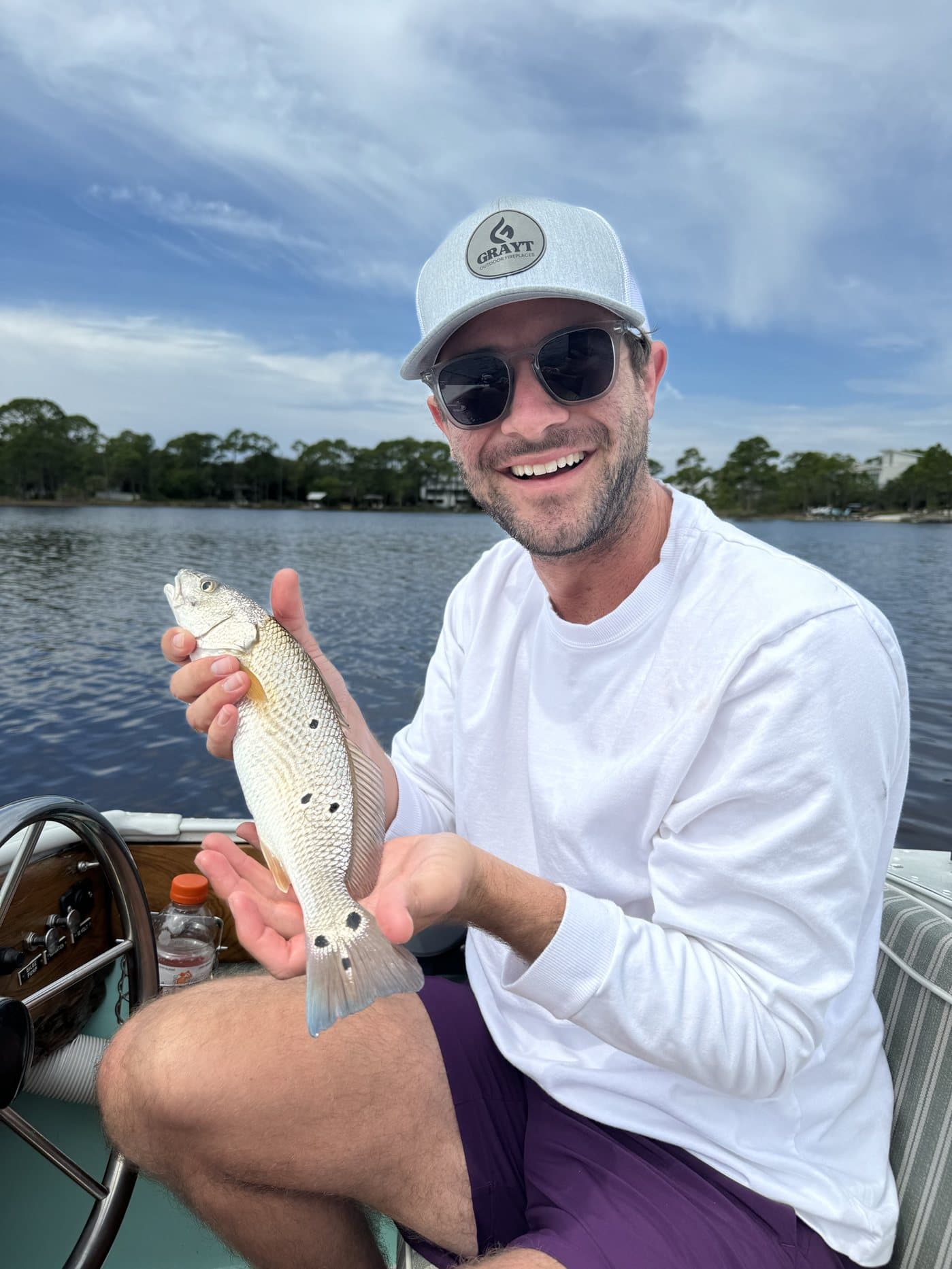 Ryan Crosby, founder of CrumbLabz, holding a redfish on a boat